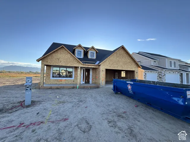 Single-story residential construction featuring a gabled roofline and two dormer windows