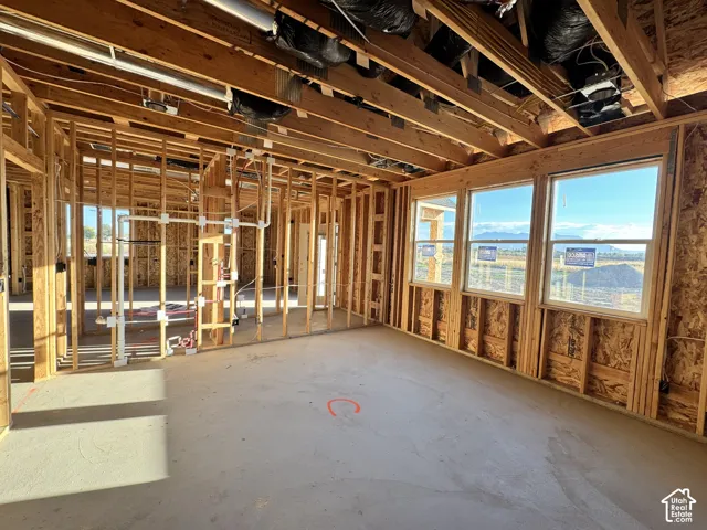 New construction framing with exposed plumbing and electrical rough-ins