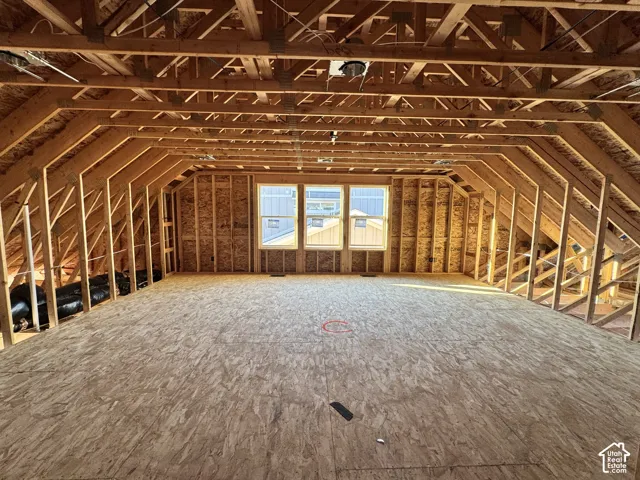 Spacious attic framing with exposed wooden rafters