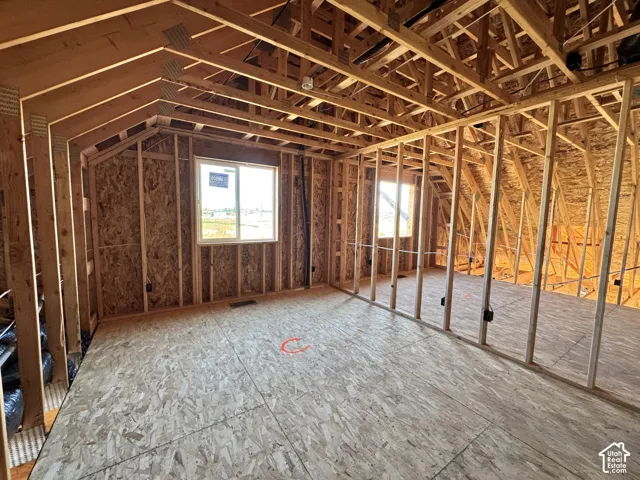 Framed interior featuring multiple windows, exposed ceiling beams, and subfloor
