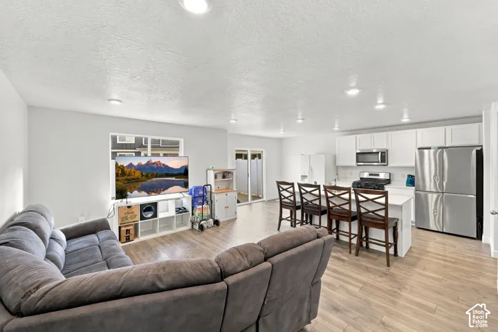 Open concept living area featuring wood-finish flooring