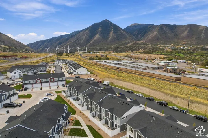 New construction community featuring multi-level residences, dark shingle roofs, and light-toned siding