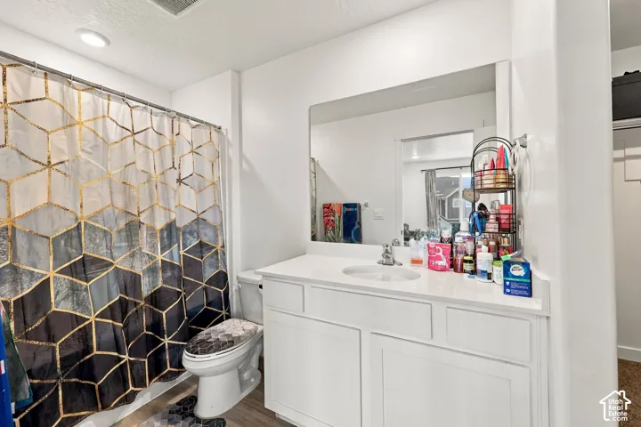 White single vanity with an integrated sink and a large wall-mounted mirror