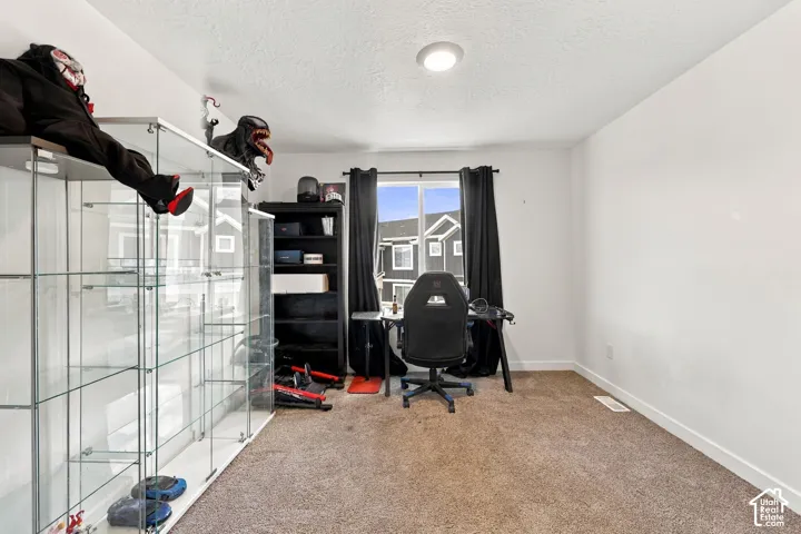 Recessed ceiling lighting, white painted walls, and soft brown carpeting