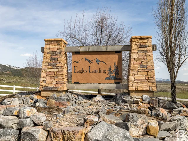 Stone pillar sign with a wood-finish panel