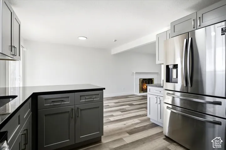 Modern kitchen featuring dark cabinetry, dark countertops, and stainless steel appliances