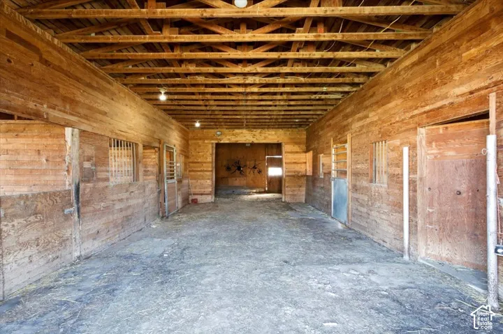 Wood-paneled interior with exposed beam ceiling
