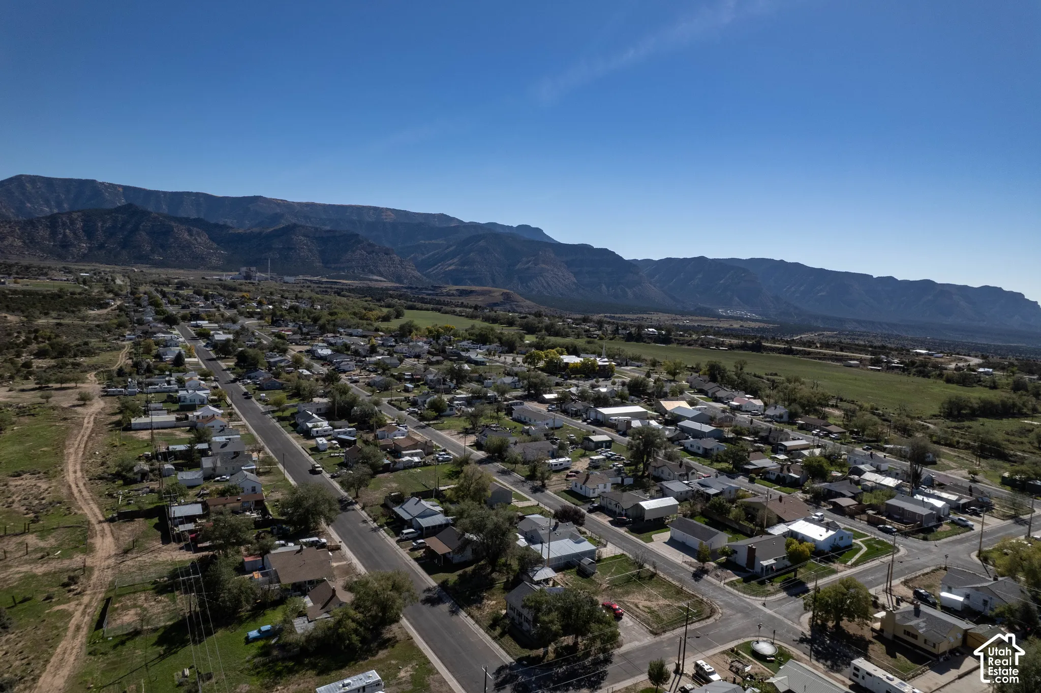 Expansive neighborhood featuring residential properties and tree-lined streets set against a prominent mountain backdrop