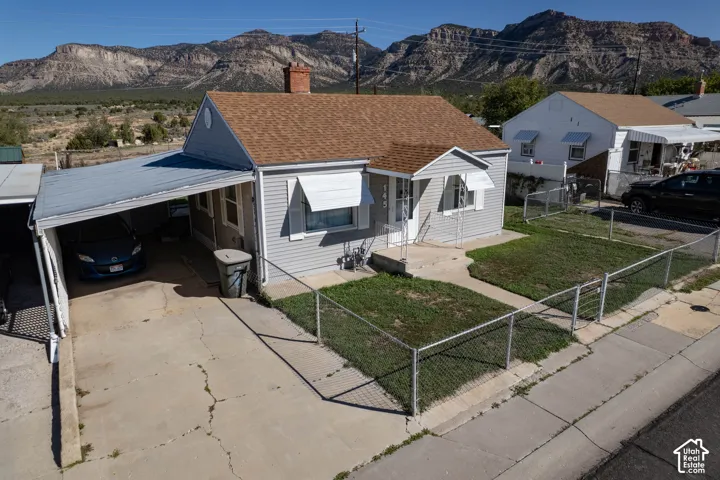Single-story residence featuring siding exterior, an attached carport, and a concrete driveway