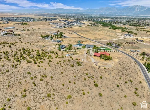 Expansive property featuring natural landscaping and a paved road access