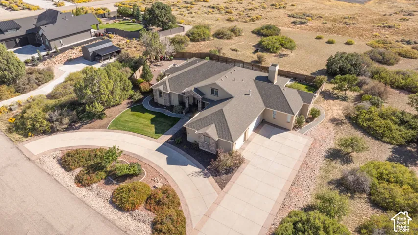 Spacious property featuring a large driveway, established lawn areas, and mature landscaping