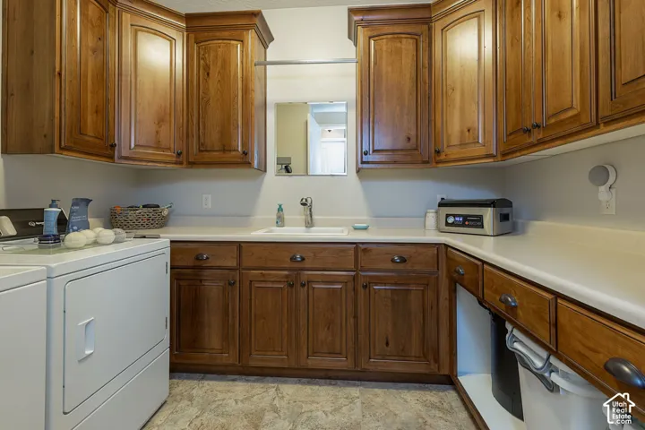 Warm wood cabinetry, integrated sink, ample countertop space, and patterned flooring