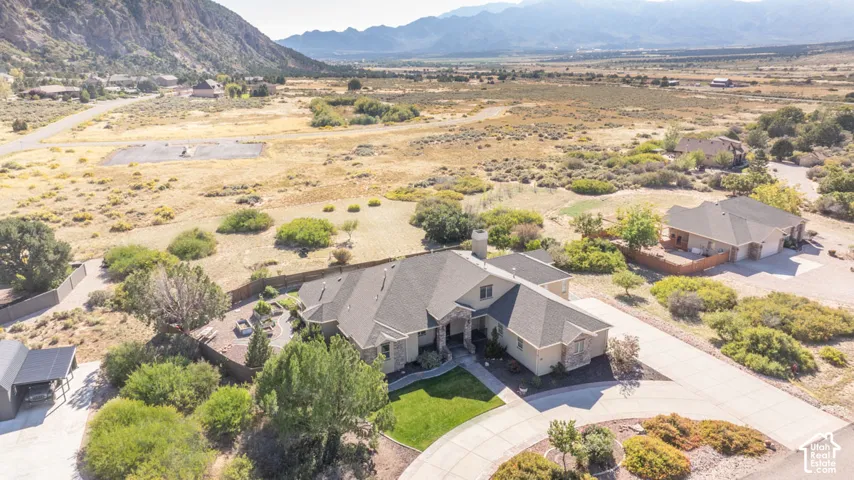 Expansive property featuring a circular drive, mature landscaping, and an attached three-car garage