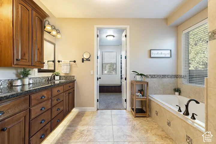 Dual vanity with dark wood cabinetry and black countertops