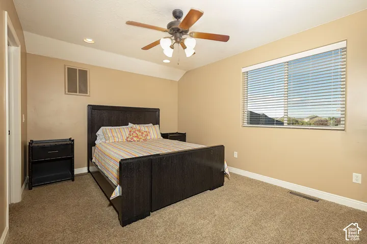 Carpeted flooring, ceiling fan with integrated lighting, recessed lighting, and a window with horizontal blinds