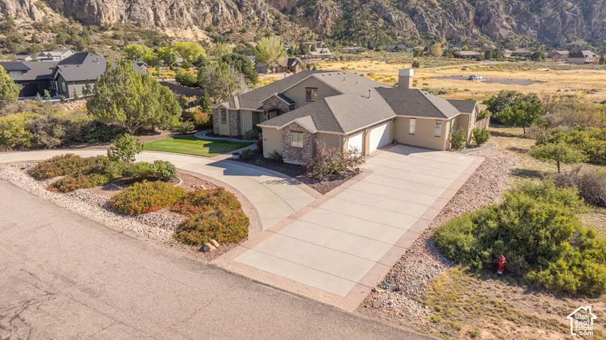 Stucco and stone exterior with an attached two-car garage