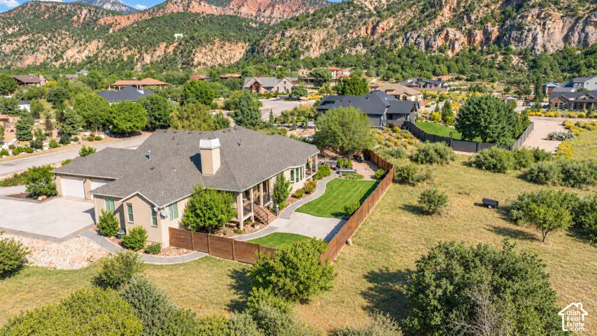 Stucco exterior with a multi-car garage and a paved driveway