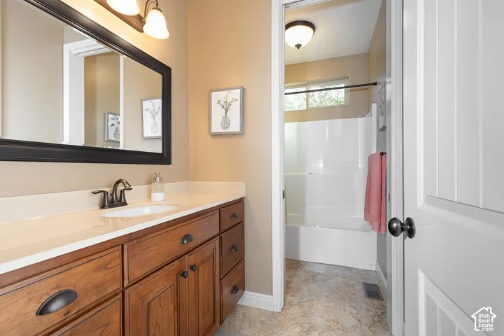 Spacious vanity with a light-colored countertop and integrated sink