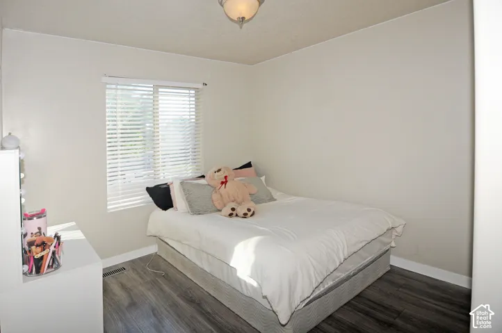 Light-toned walls with a window featuring horizontal blinds
