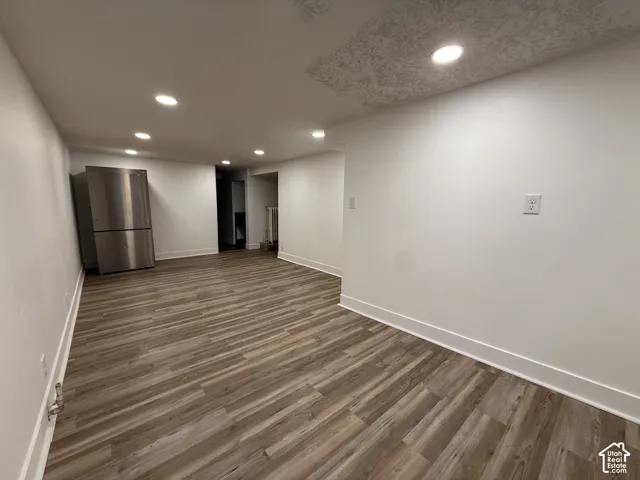 Living room with refrigerator for kitchen area
