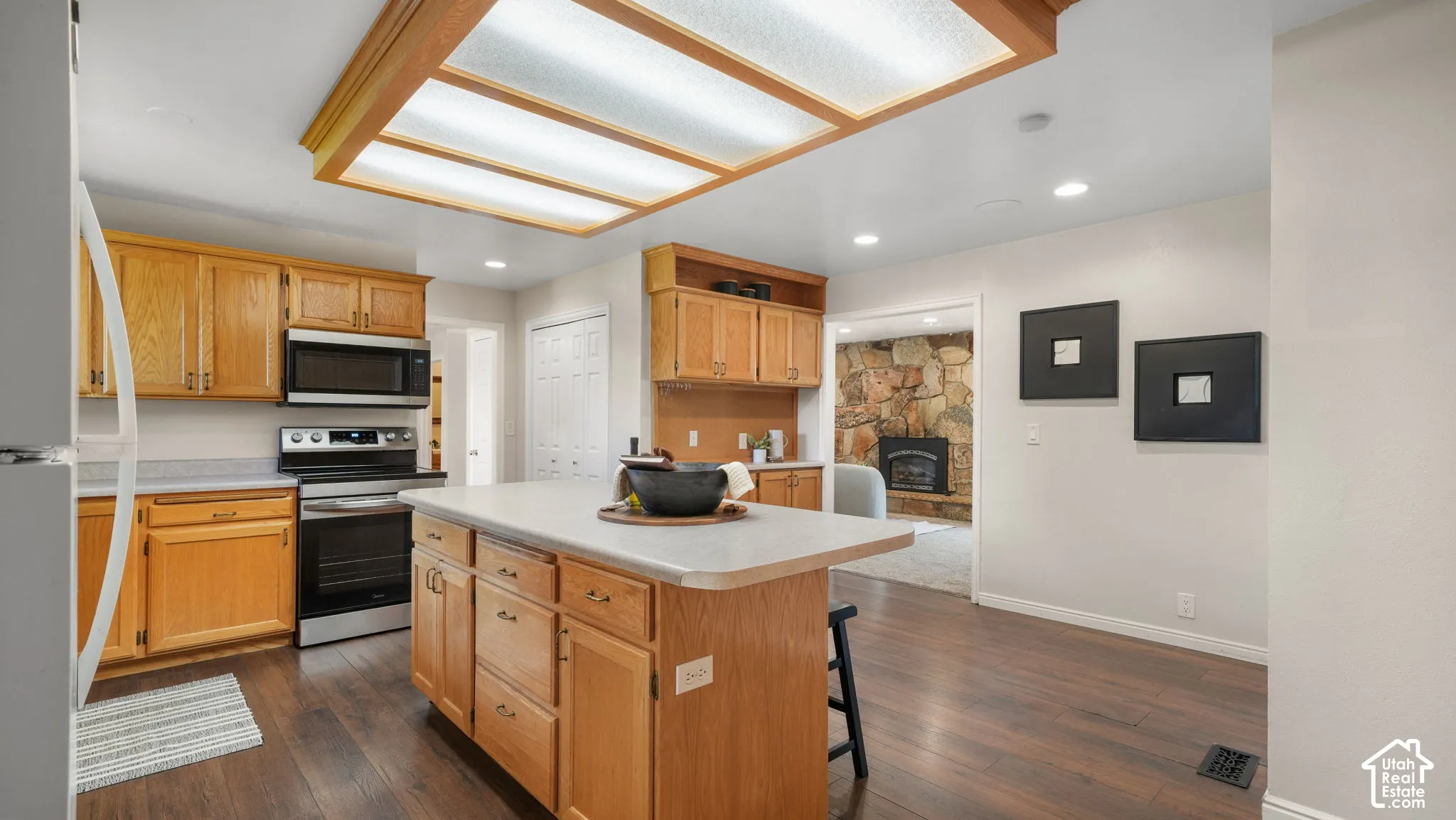 Kitchen featuring wood-finish flooring, recessed lighting, and a center island with countertop seating