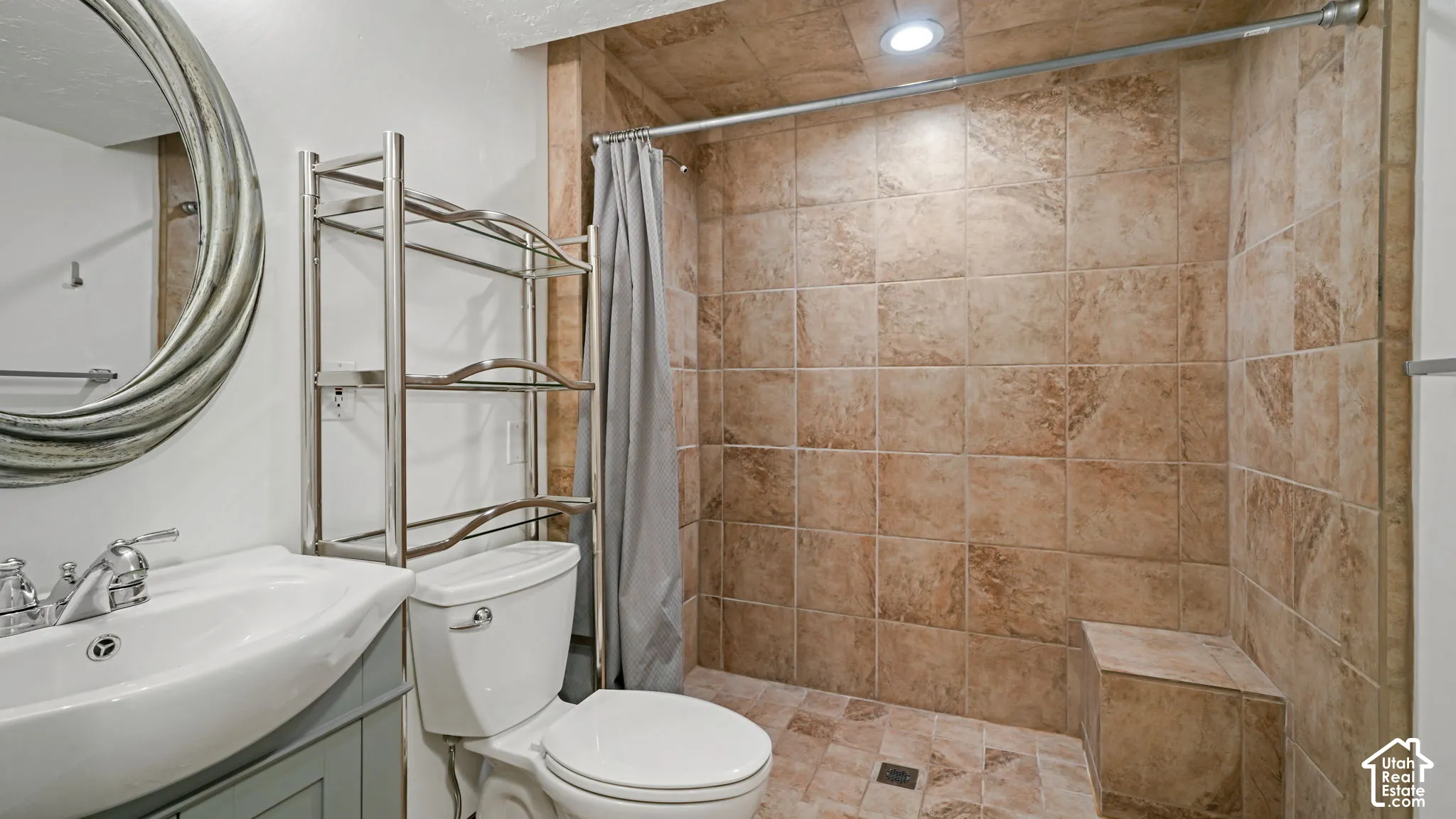 Walk-in shower with tiled walls and built-in bench