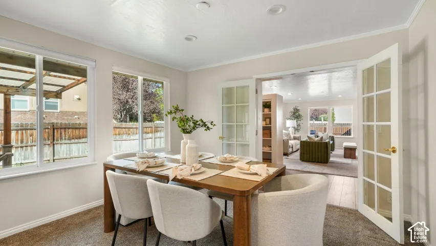 Dining space with recessed lighting, dual windows, and French doors