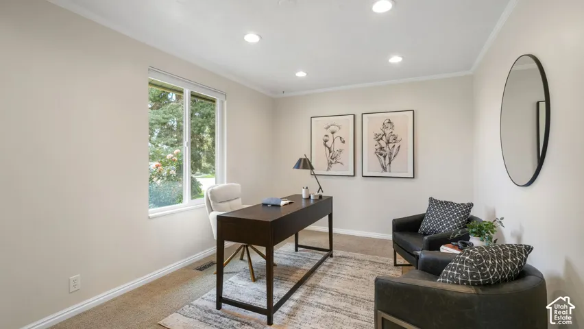 Recessed ceiling lighting, crown molding, and a large window with white trim