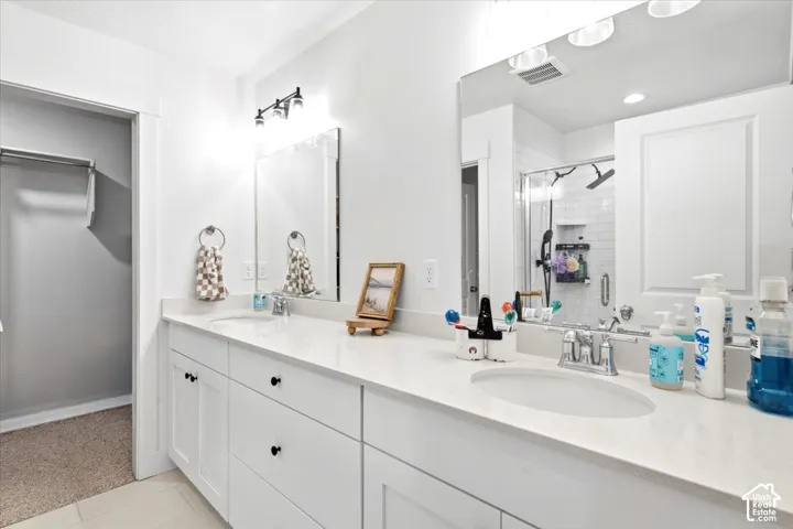 Dual vanity with white cabinetry and black hardware