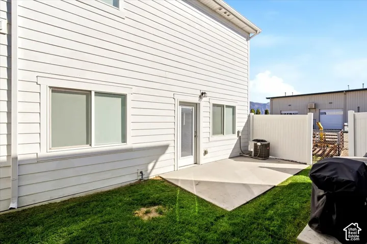 White horizontal siding exterior with multiple windows and a glass-paneled door