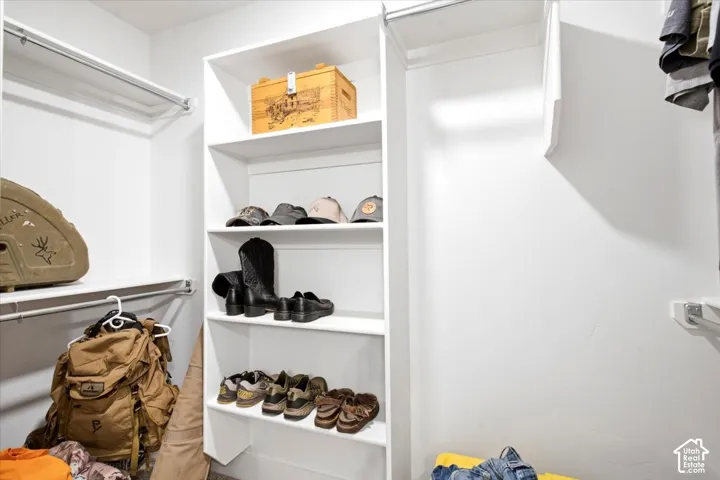 White shelving units and hanging rods provide ample storage