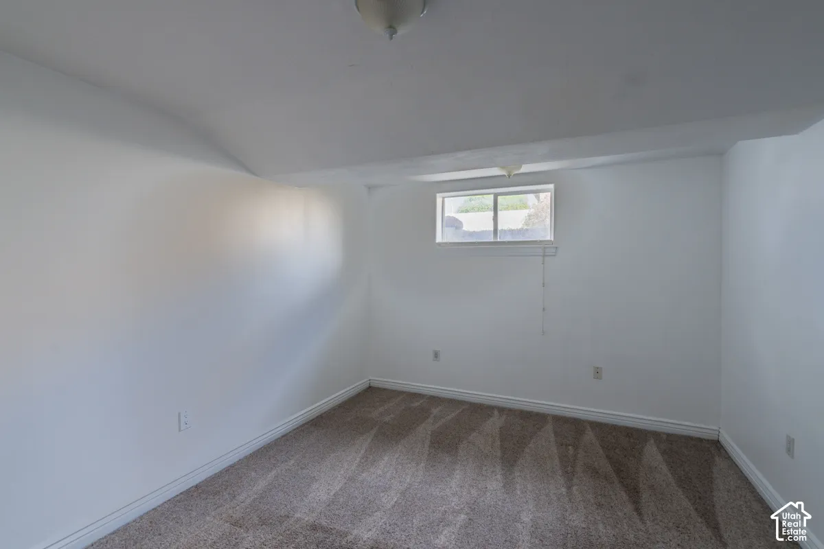 Recessed window with white trim, wall-to-wall carpeting, white painted walls, and a ceiling-mounted light fixture
