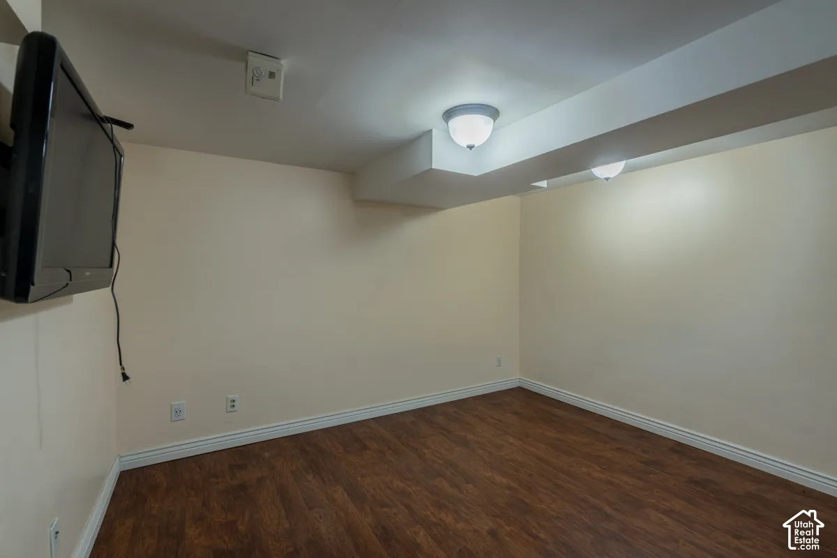 Wood-finish flooring, neutral wall tones, and recessed ceiling lighting