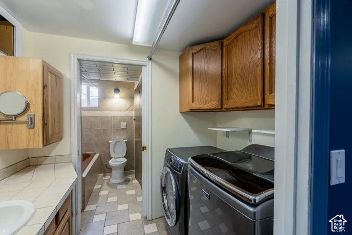 Wood-finish cabinetry, tile flooring, built-in shelving, and recessed lighting