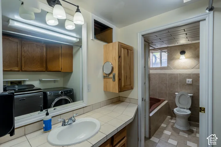 Bathroom vanity with an integrated sink and tiled countertop