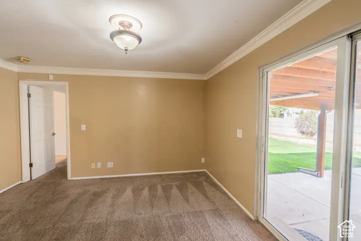 Neutral-toned wall paint, crown molding, and a ceiling-mounted light fixture
