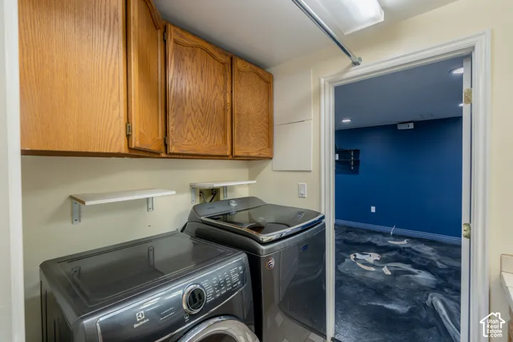 Laundry area featuring built-in wood cabinetry and open shelving