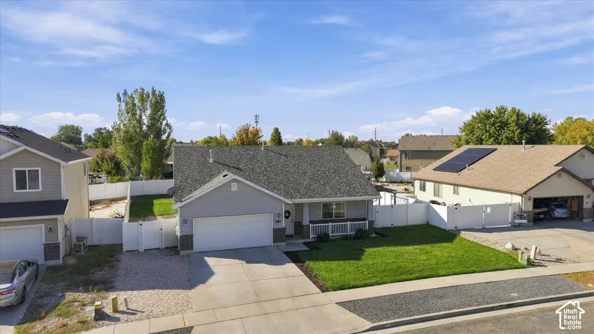 Single-story residence with a gray exterior and white trim, featuring a dark gray shingle roof and an attached two-car garage
