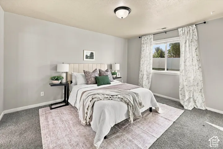 Neutral-toned walls complement plush carpeting