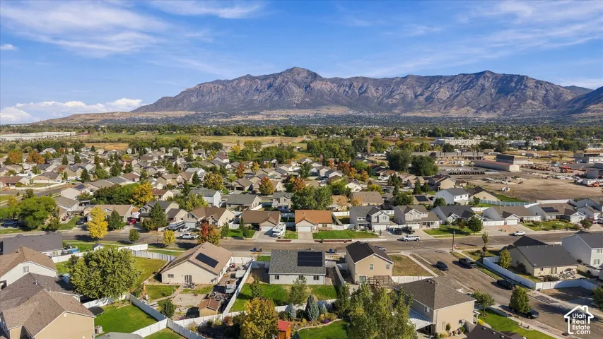 Residential neighborhood with established streets and mature trees, set against a prominent mountain range
