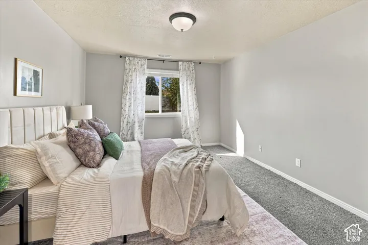Recessed window with white trim, light gray walls, and gray carpeting