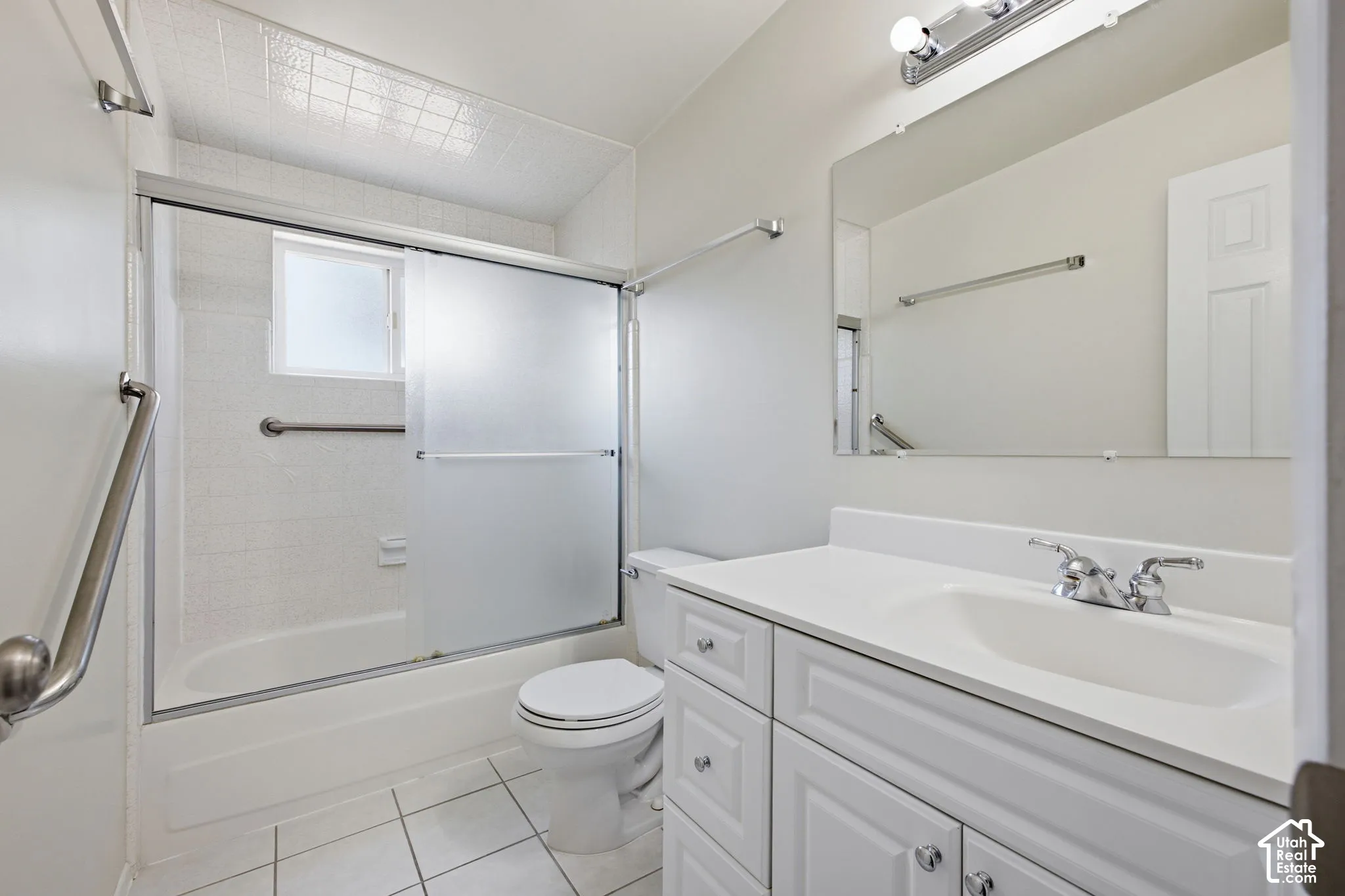 White vanity with paneled doors and drawers, integrated sink, and chrome faucet
