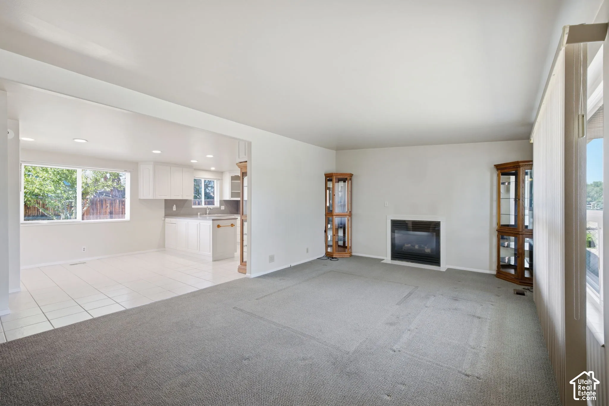 Recessed lighting, kitchen featuring white cabinetry, under-mount sink, and tiled flooring