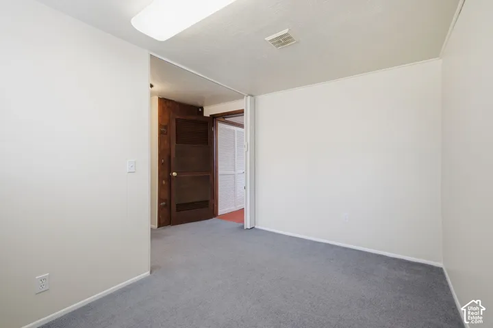 Light-colored walls with gray carpeting throughout
