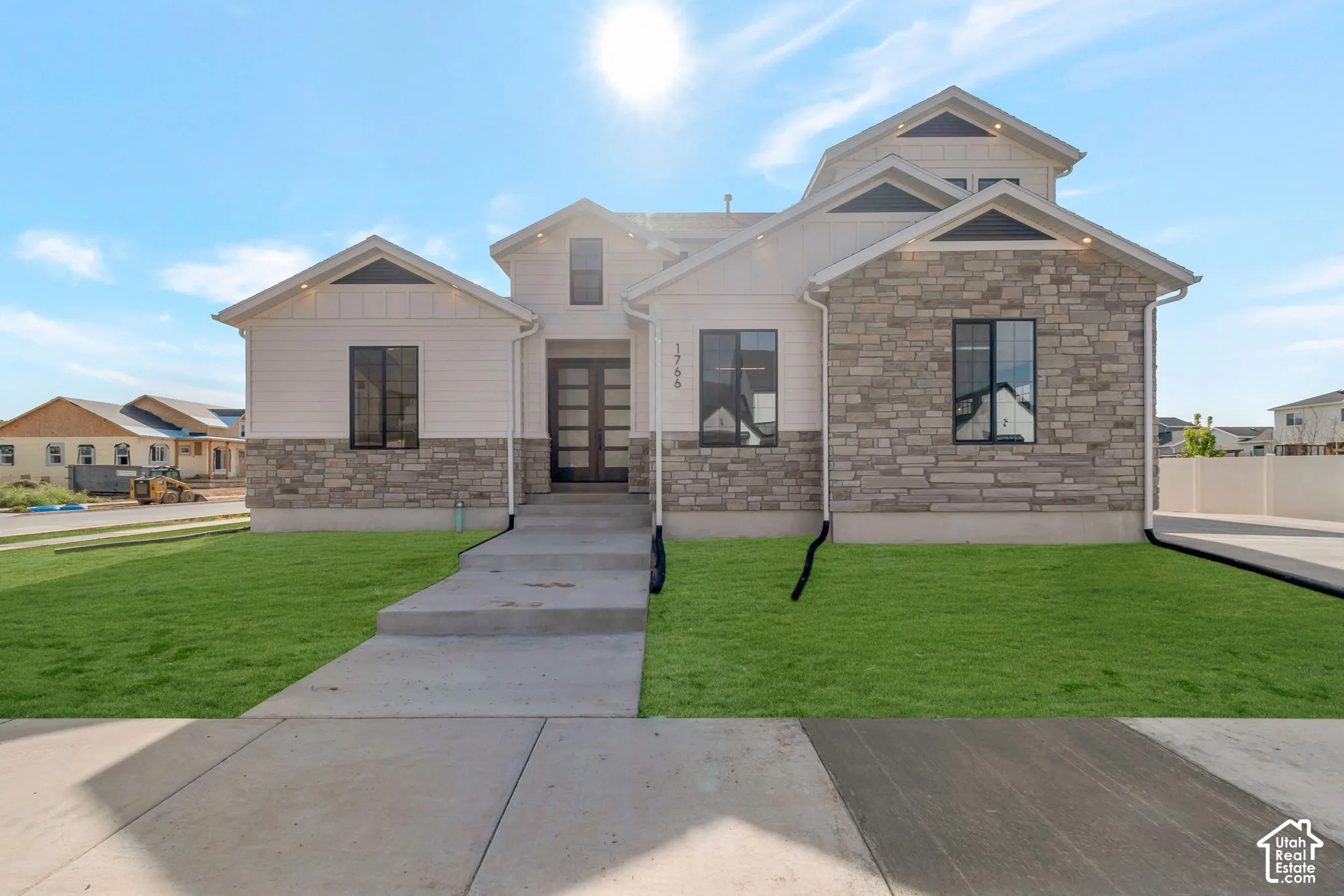 Contemporary exterior with stone facade and vertical siding accents