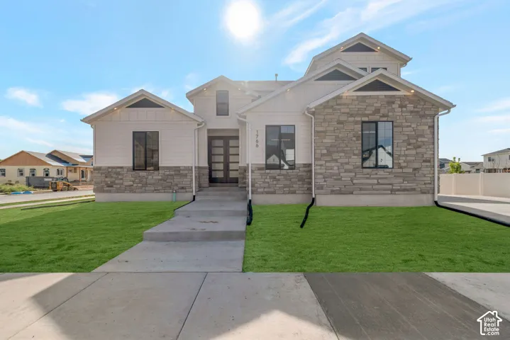 Contemporary exterior with stone facade and vertical siding accents