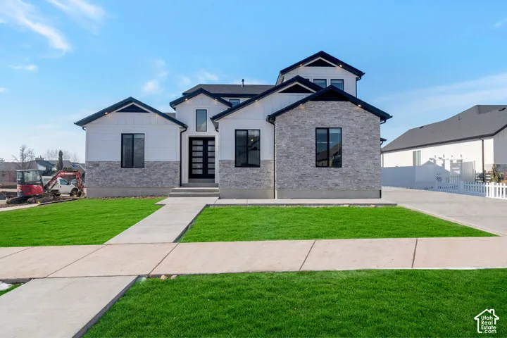 Contemporary exterior with white siding and gray stone accents