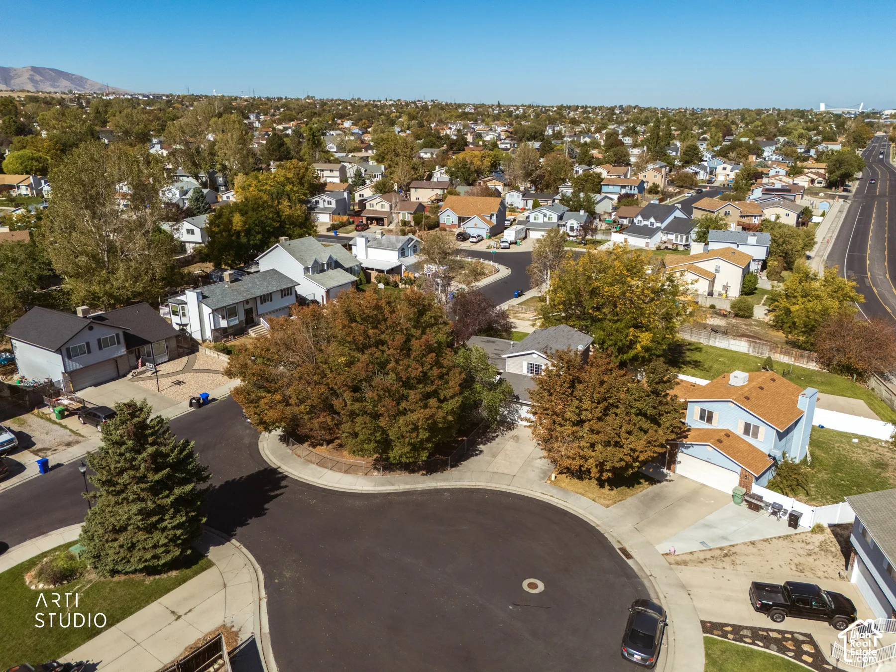 Residential neighborhood featuring numerous single-family homes, mature trees, and paved streets