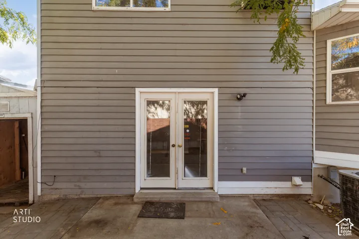 Gray horizontal siding exterior with a concrete patio