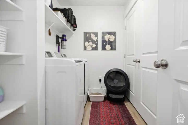 White walls, built-in shelving, light wood-finish flooring, and white paneled doors